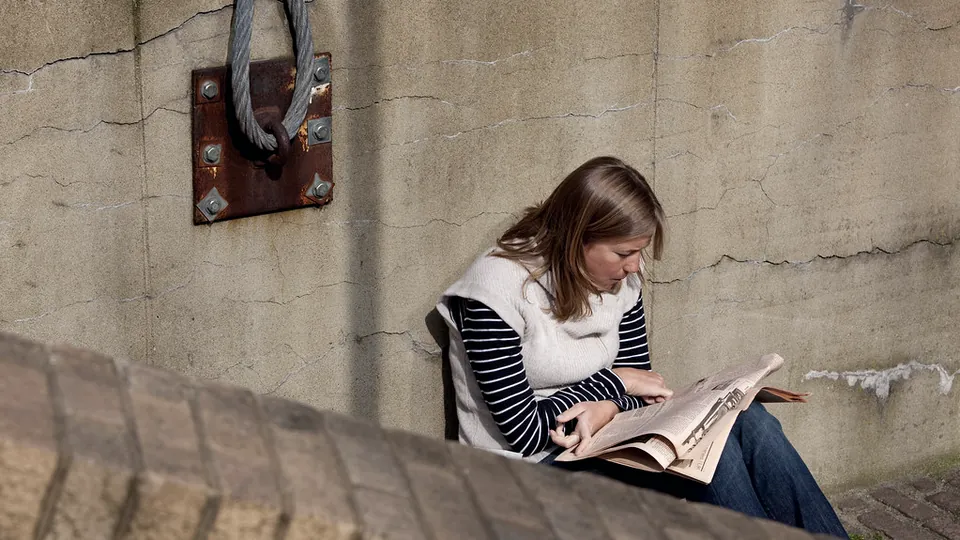A tablet beside a printed financial newspaper, ready for reading the markets